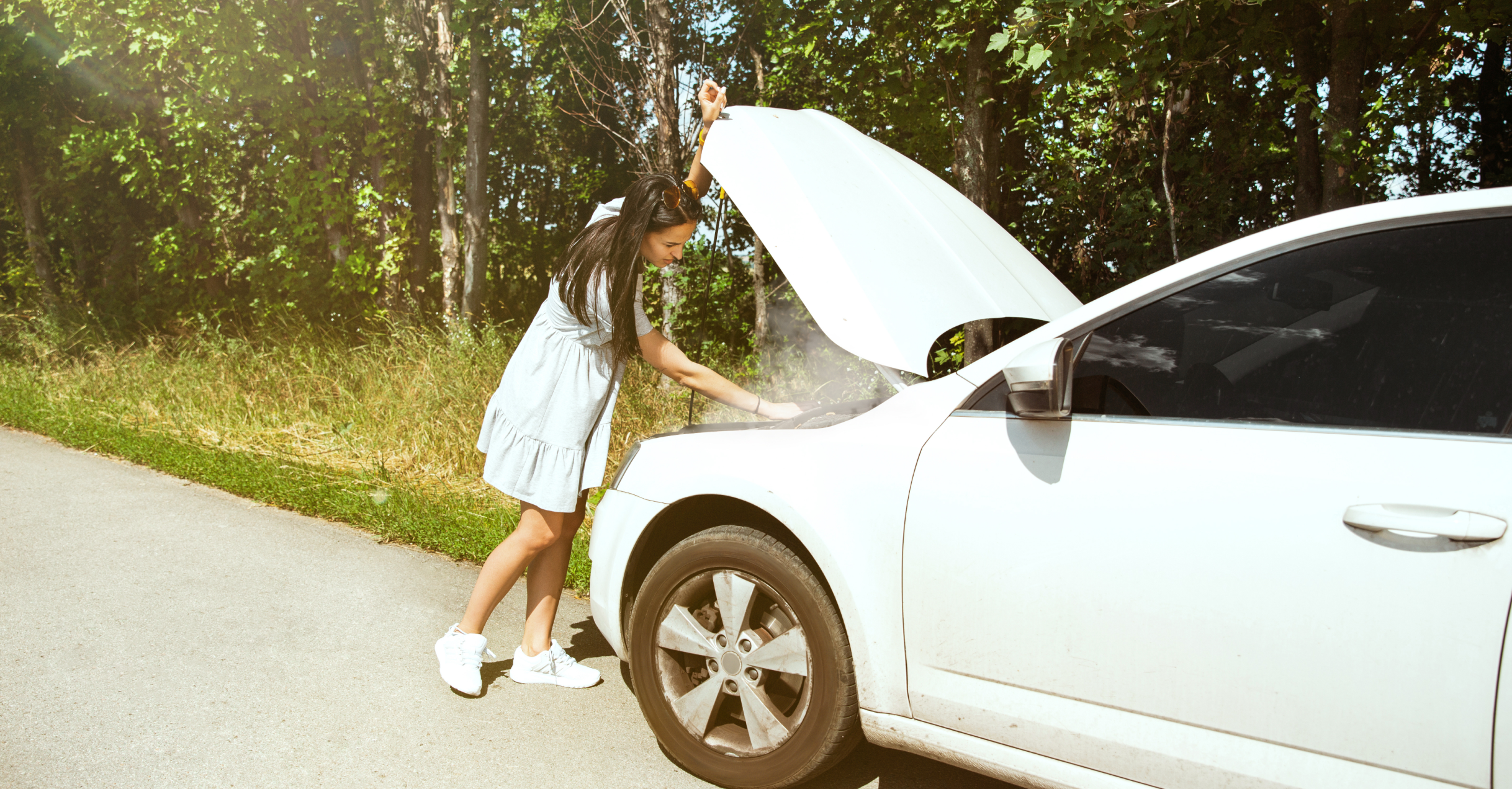 A Long Haired Woman In A White Dress Checking Her Car Engine.