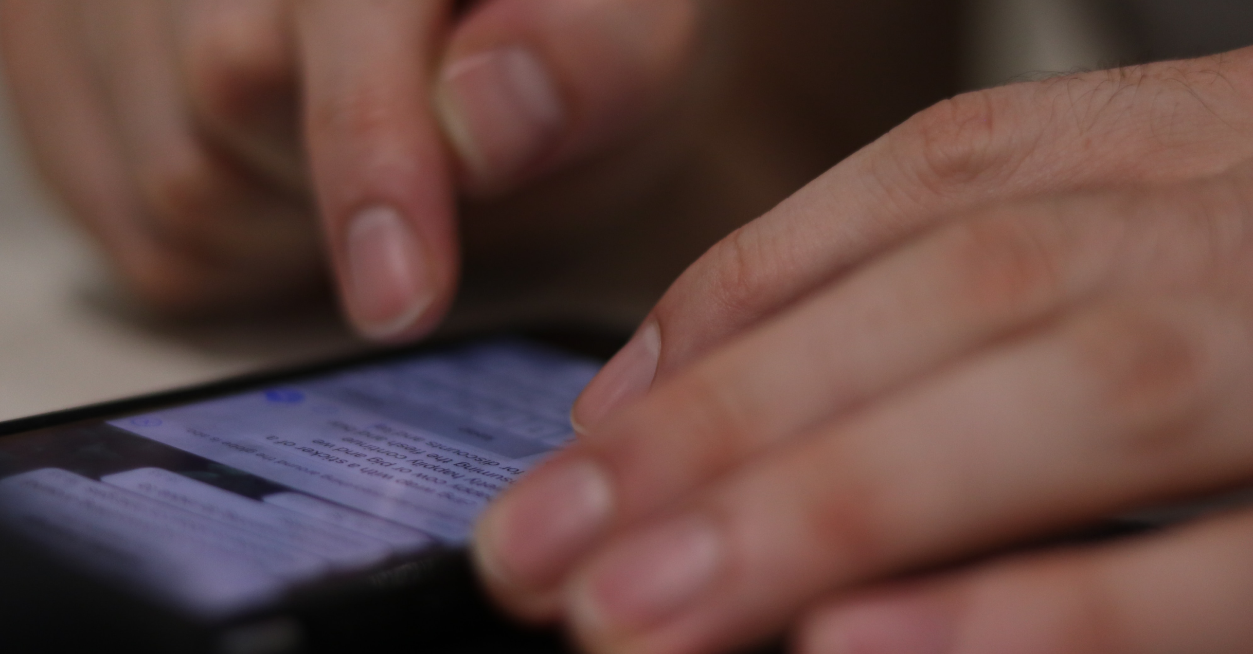 A Pair Of Hands Typing On A Cell Phone.