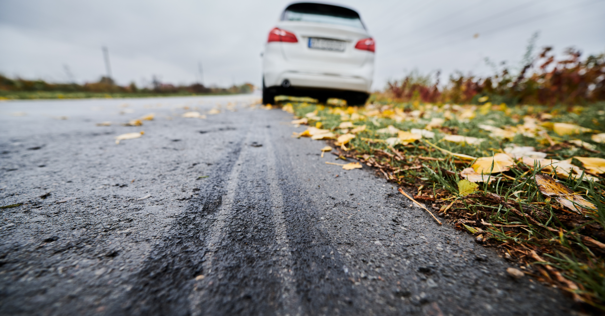 A White Car Stranded On A Empty Road.